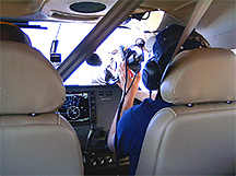 Terry Davise filming from Cockpit of Airplane